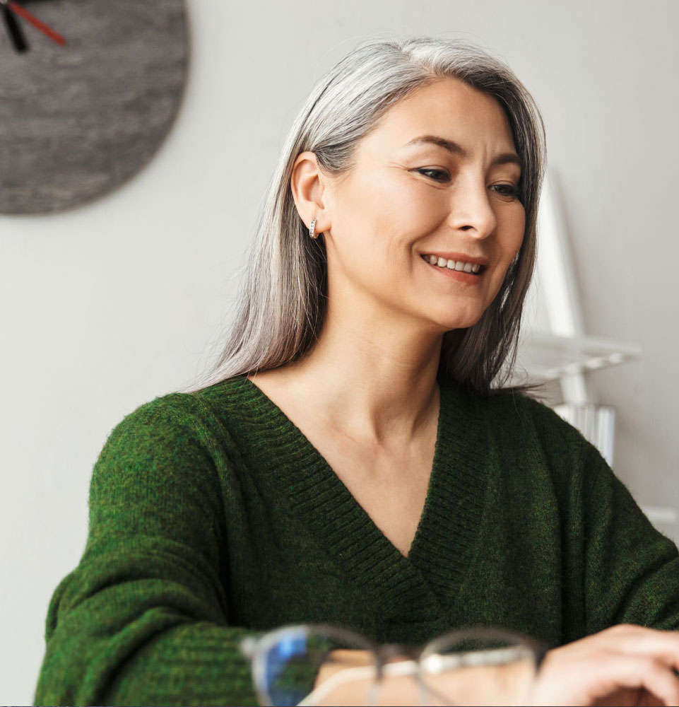 middle aged woman settingappointment for full arch implants